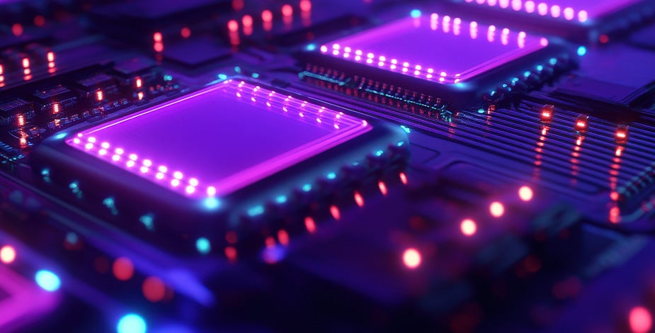 Macro photograph of glowing purple and magenta memory chips on a circuit board
