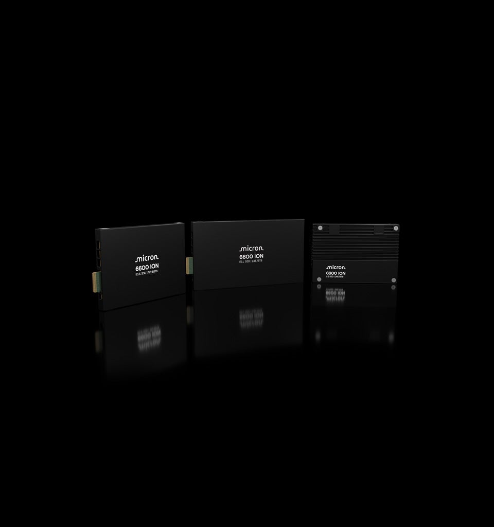 Three Micron 6600 ION SSDs stacked on black with mirrored reflections